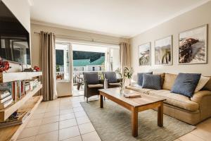 a living room with a couch and a table at 20 River Club Villas in Plettenberg Bay