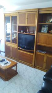 a living room with a large entertainment center with a tv at Apartamento La Basella in Villanueva de Arosa