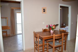 a dining room table with a vase of flowers on it at Angelica in Perivólion