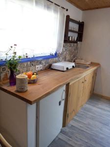 a kitchen with a counter with a sink and a window at Sandra Studio in Lachania