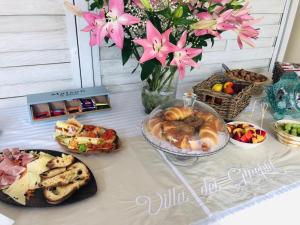 a table with a buffet of food and flowers at Villa dei Ginepri in Gallipoli