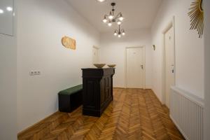 a living room with a table and a chandelier at 1790 Margarethengasse Guesthouse in Sibiu
