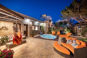 un patio al aire libre con piscina y muebles en Paradisos luxury villas next to beach, en Koutsourás