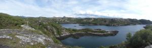 an aerial view of a lake in the mountains at Achmelvich View self catering in Lochinver