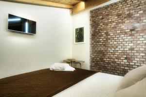 Postel nebo postele na pokoji v ubytování Palazzo Eugenia Suites