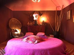 1 dormitorio con 1 cama con colcha rosa en Castle of Verges, en Verges