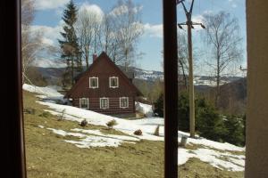a window view of a house in the snow at Chata Diana in Vítkovice
