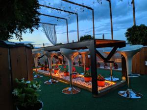 a patio with a table and chairs and plants at Sky Apartments in Strumica