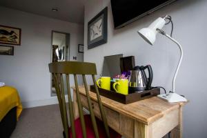 a room with a desk with a lamp and a chair at Dunstan House in Burnham on Sea
