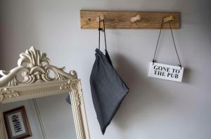 a mirror and a sign that says come to the pub at Dunstan House in Burnham on Sea