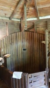 a bathroom with a wooden wall with a towel at Domaine de Robinson in Les Anses-dʼArlets