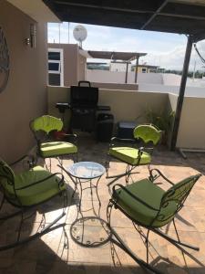a group of chairs and a piano on a patio at Ave. Duarte k3/12, Residencial Palma Real, Santiago, RD in Arenoso