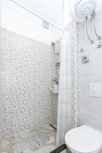 a white bathroom with a toilet and a shower at Apartment Matea in Split