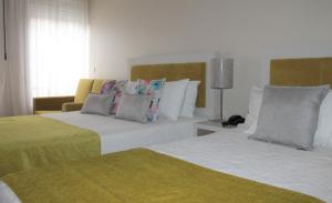 a hotel room with a bed and two nightstands at Classico in Vila Real