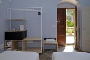 a bedroom with a bed and a mirror and a door at Regia Trazzera in Ragusa