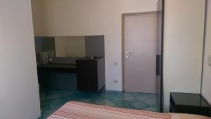 a bedroom with a mirror and a desk and a bed at Albergo Villa Anna in Anzio