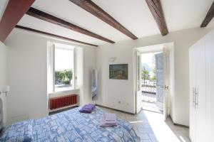 a bedroom with a bed and two windows at Ranzoni 3 sub. 1 in Verbania