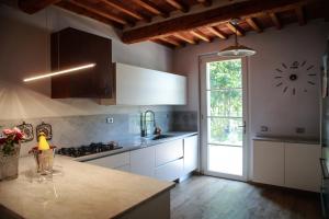 a kitchen with a counter and a clock on the wall at Tipical Tuscany House near Lucca! in Capannori