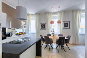a kitchen and dining room with a table and chairs at Hedone Luxury Apartment with FREE PARKING in Pula