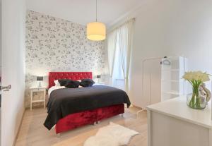a bedroom with a red bed with two cats on it at Hedone Luxury Apartment with FREE PARKING in Pula