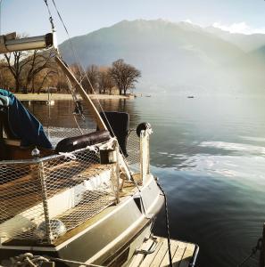 un bateau est amarré sur un plan d'eau dans l'établissement Sailboat, Do-Minus Design Retreat & SPA, à Locarno