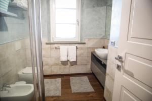 a bathroom with a sink and a toilet and a window at Tipical Tuscany Apartment near Lucca! in Capannori +13 photos