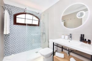 a bathroom with a sink and a toilet and a shower at HD Parque Cristobal Tenerife in Playa de las Americas