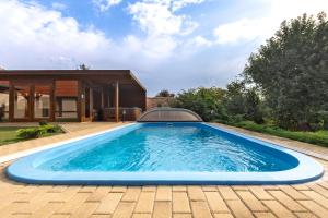 a swimming pool in the backyard of a house at Virág Vendégház in Hercegkút