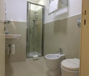 a bathroom with a shower and a toilet and a sink at Sangiuliano114 B&B in Catania