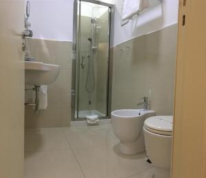 a bathroom with a toilet and a sink and a shower at Sangiuliano114 B&B in Catania