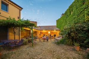 a yard with tables and chairs and a building at Ventanas in Villamassargia