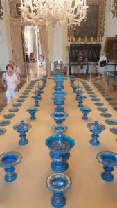 a row of blue glass vases sitting on a table at Guest House Seme Di Faggio in Miasino
