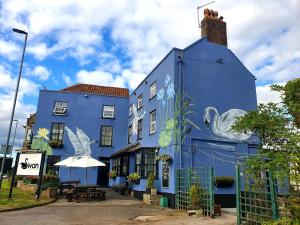 a blue building with a table in front of it at The Swan Hotel in Almondsbury