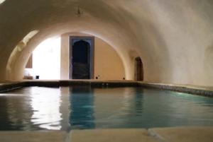 a swimming pool in a building with water in it at Demeure de Digoine "Chambre d'Hotes" in Bourg-Saint-Andéol