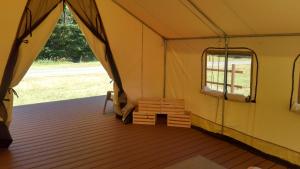 a tent with a bench inside of it at Redwood Meadows RV Resort in Crescent City