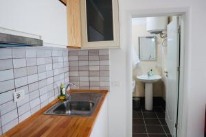a small kitchen with a sink and a mirror at Dua Apartments in Shëngjin +30 photos