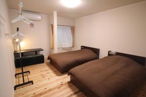 Ένα ή περισσότερα κρεβάτια σε δωμάτιο στο GUEST HOUSE Googoo