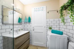 a white bathroom with a sink and a toilet at The Colors House, 653 y 654 - Private Apartment in Costa Teguise