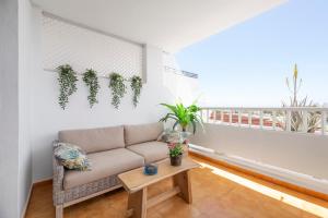 a living room with a couch and a table at The Colors House, 653 y 654 - Private Apartment in Costa Teguise +68 photos