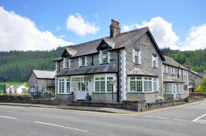 an old stone house on the side of the road at Oakfield Guest House in Betws-y-coed