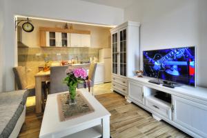 a living room with a vase of flowers on a table at Apartments Banicevic in Tivat