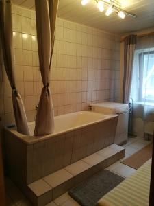 a bathroom with a bath tub in a room at Ferienwohnung zum Bergmann in Annaberg-Buchholz