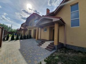 a house with a brick driveway in front of it at Апартаменты премиум класса на Гвардейской in Uzhhorod