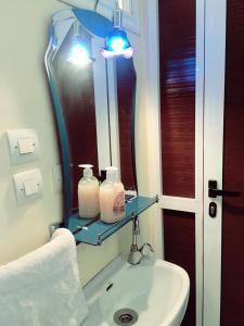 a bathroom with a sink and a mirror at Imsouane soul lodge in Imsouane