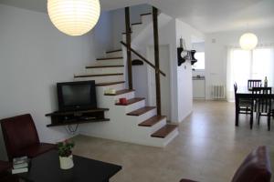 a living room with a staircase and a dining room at Complejo Tridente in Pinamar