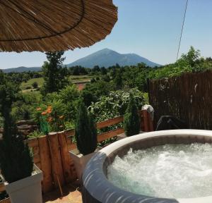 a hot tub with a view of a mountain at Rtanjski konak in Boljevac