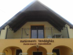 a building with a sign on the front of it at Határmenti Vendégház in Zsira
