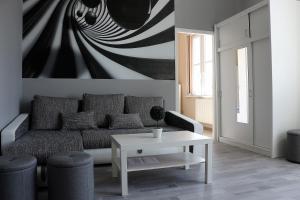 a living room with a couch and a table at CentRoom Apartman in Sátoraljaújhely