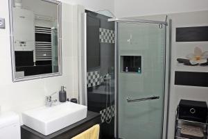 a bathroom with a sink and a shower at CentRoom Apartman in Sátoraljaújhely