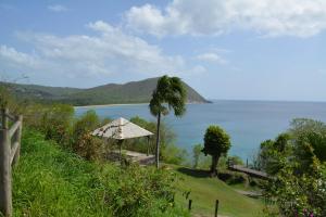 a gazebo on a hill next to the ocean at Middle Country 97-1 "la recette du bonheur" in Deshaies